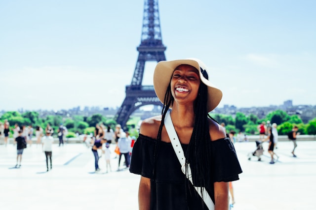 Black Woman Smiling in Front of the Eiffel Tower