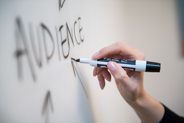 Person Writing On Whiteboard - Create A Content Strategy