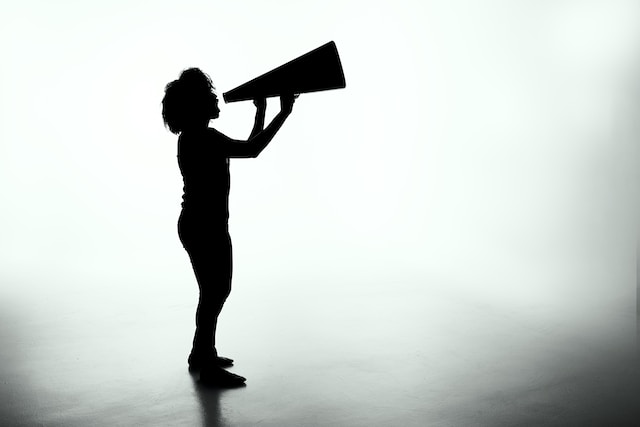 Silhouette of Woman Holding Megaphone