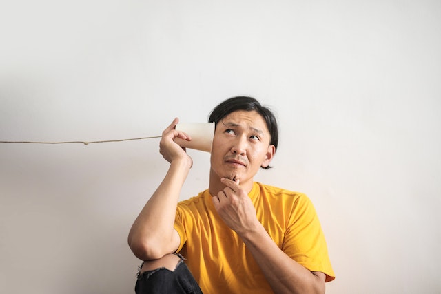 Man Holding Paper Landline Phone