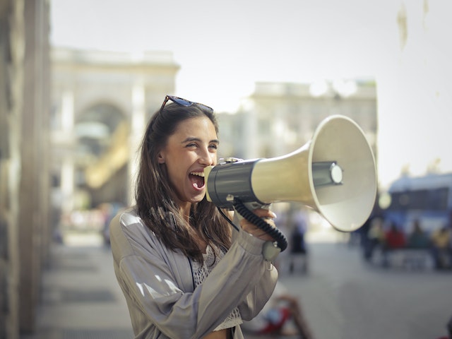 Cheerful Woman With Loud Speaker
