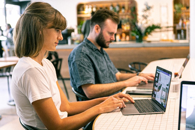 Woman Using Laptop in Coworking Space